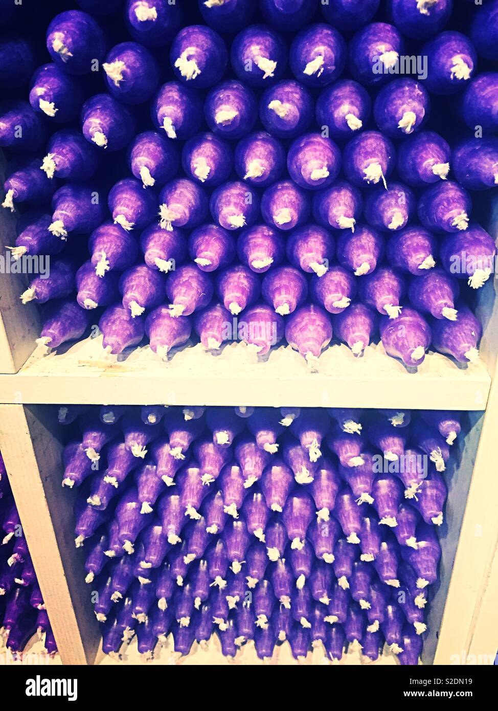 Stacks of purple candles on display in a retail store, USA - Smartphone Captured Stock Image