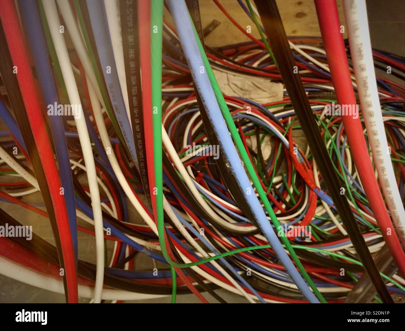 A tangled mess of electrical cables, close-up - Smartphone Captured Stock Image