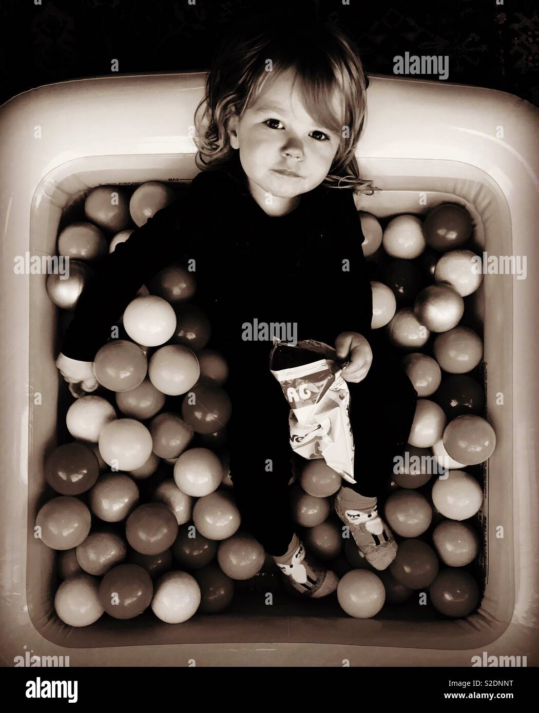 My friends daughter owning the ball pit.. Stock Photo