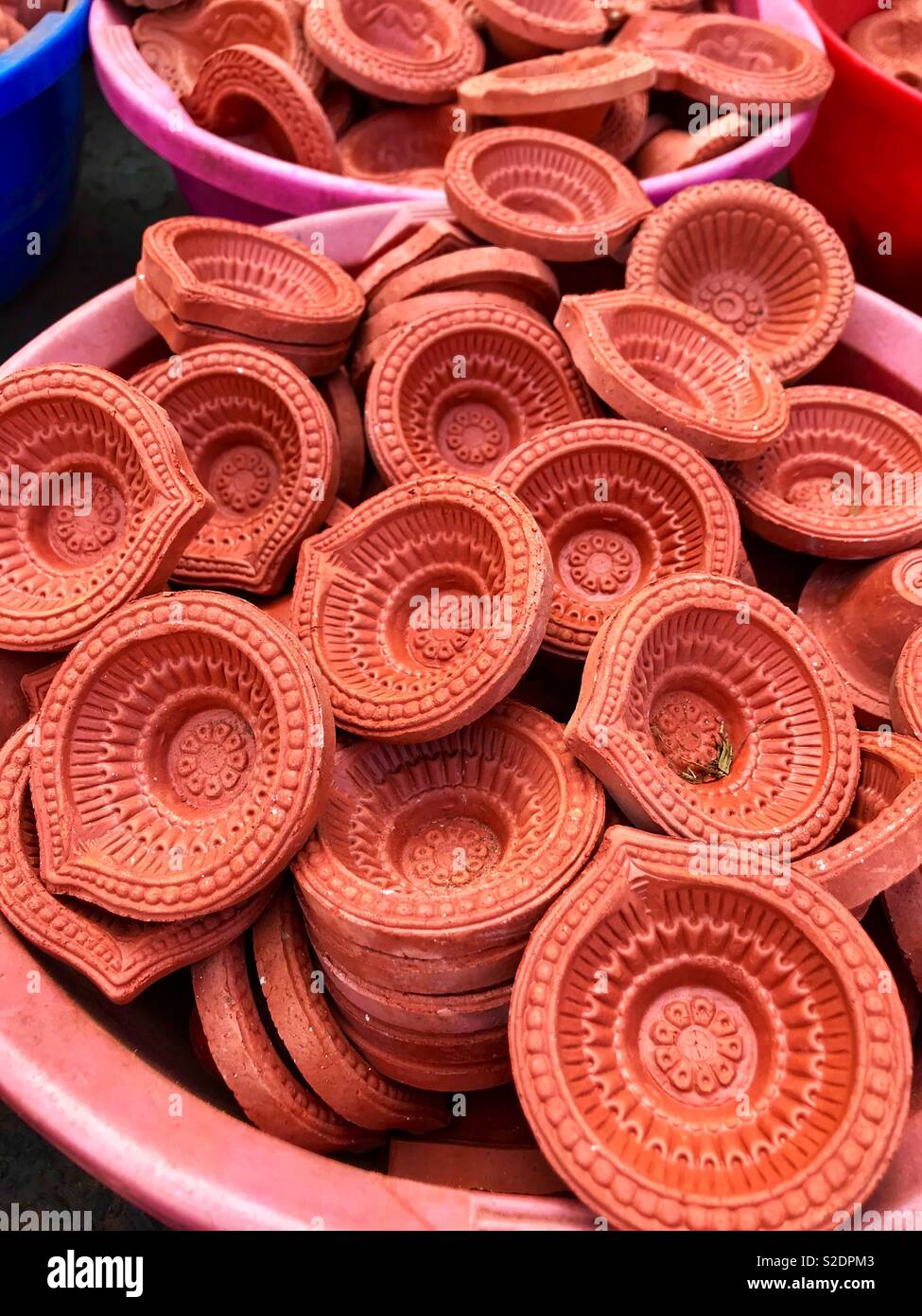 Terracotta red Diwali traditional lamps for sale in the market Stock Photo