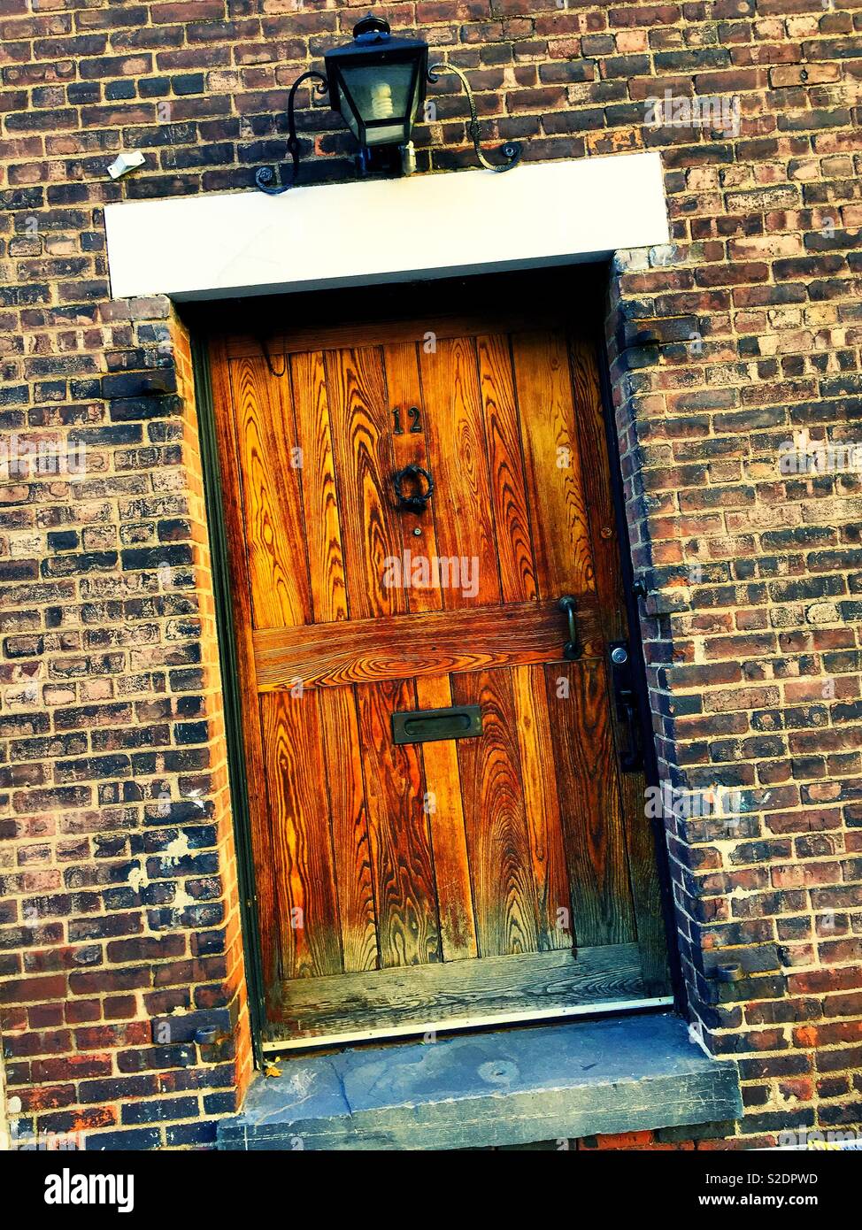 Heavy hand hewn wooden door in Washington mews , Greenwich Village, NYC, USA - Smartphone Captured Stock Image