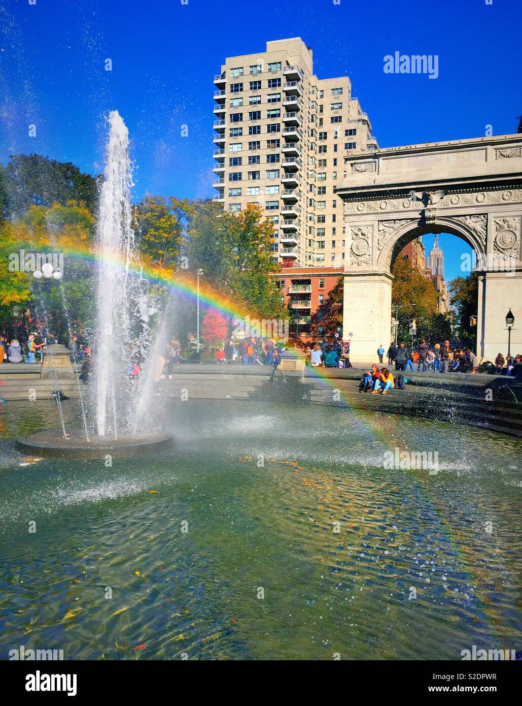 Rainbow reflection in the water fountains at Washington Square Park, NYC, USA - Smartphone Captured Stock Image