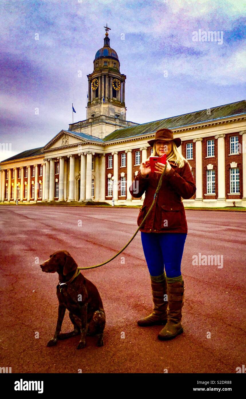 Dog and Texting Lady In Front of Large Stately Building - Smartphone Captured Stock Image