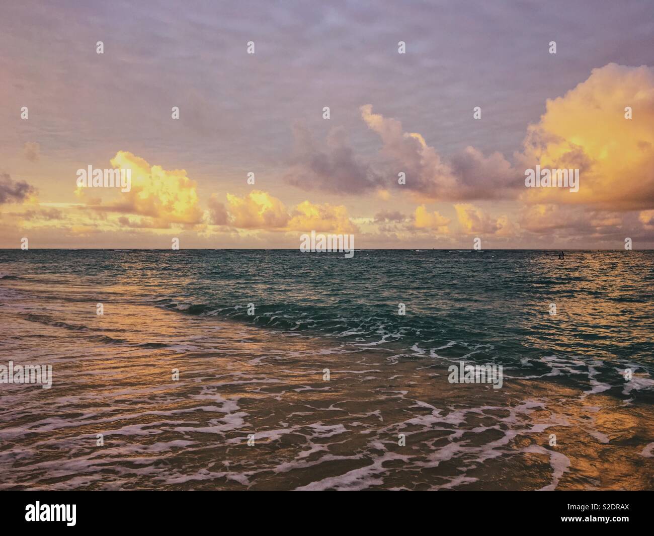 Seascape on Hawaii with warm ocean water washing up onto beach. - Smartphone Captured Stock Image