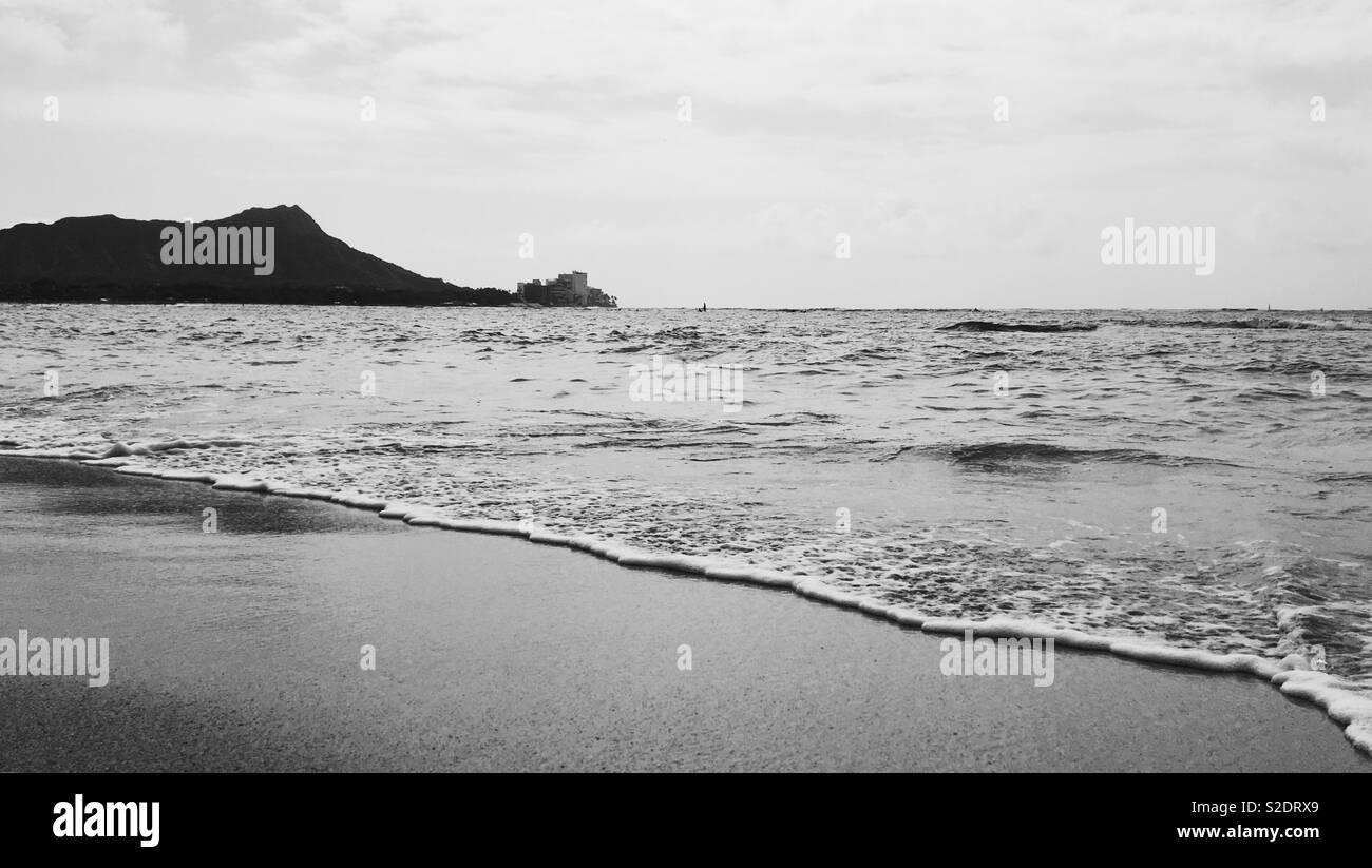 Silhouette of Diamond Head Mountain from Waikiki beach. In black and white. Room for text. Stock Photo