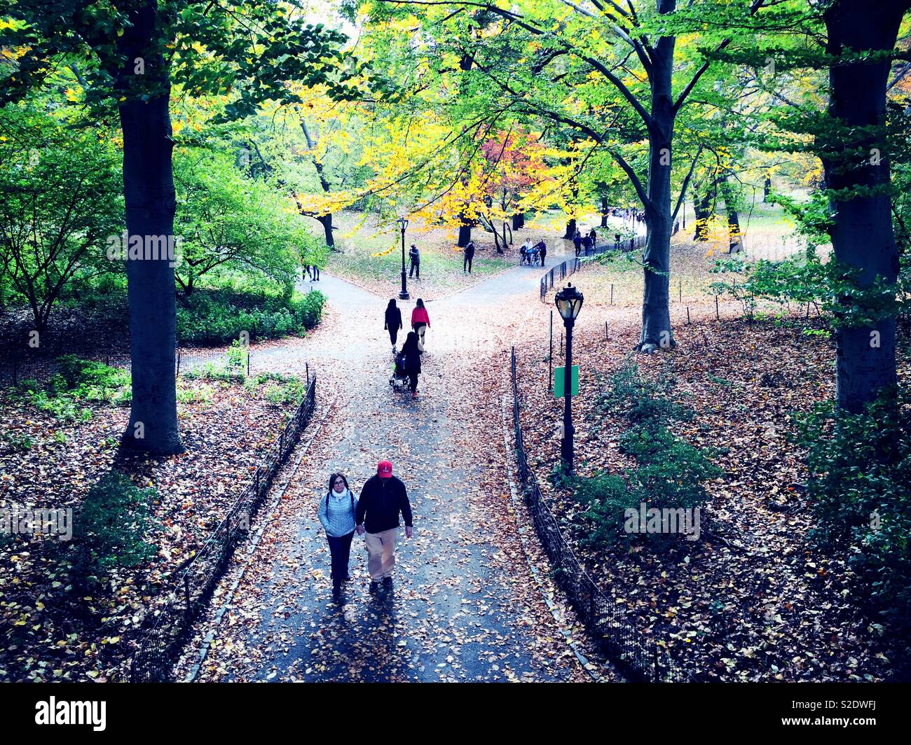 NYC A couple and other New Yorkers enjoying central park near Glade arch on an autumn afternoon, NYC, USA - Smartphone Captured Stock Image