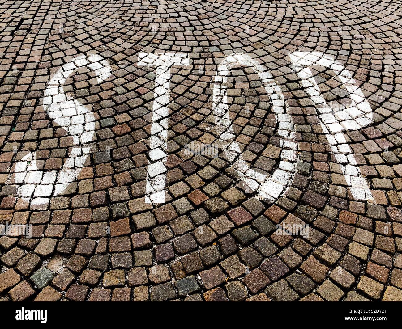 Stop road marking painted on a cobbled street - Smartphone Captured Stock Image