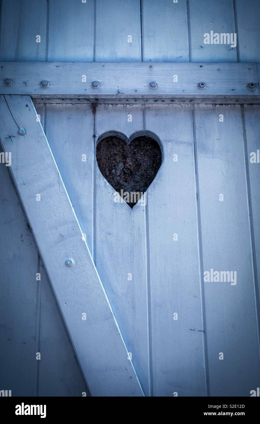 Heart carved in to wooden door - Smartphone Captured Stock Image