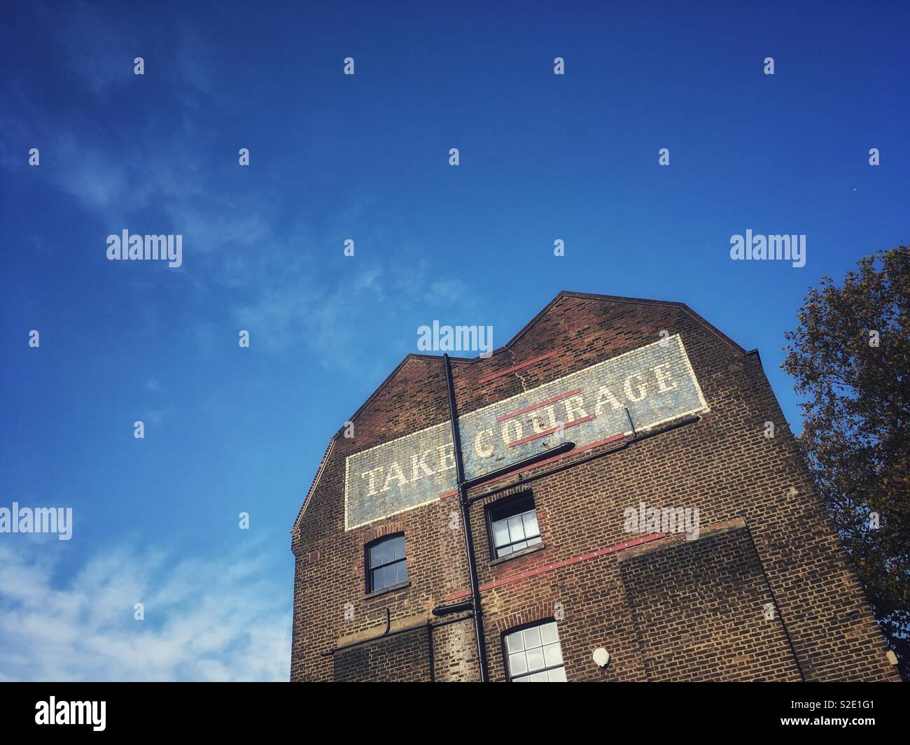 Take Courage Advert on What used to be The Courage & Co. Ltd Brewery in Southwark London in England - Smartphone Captured Stock Image