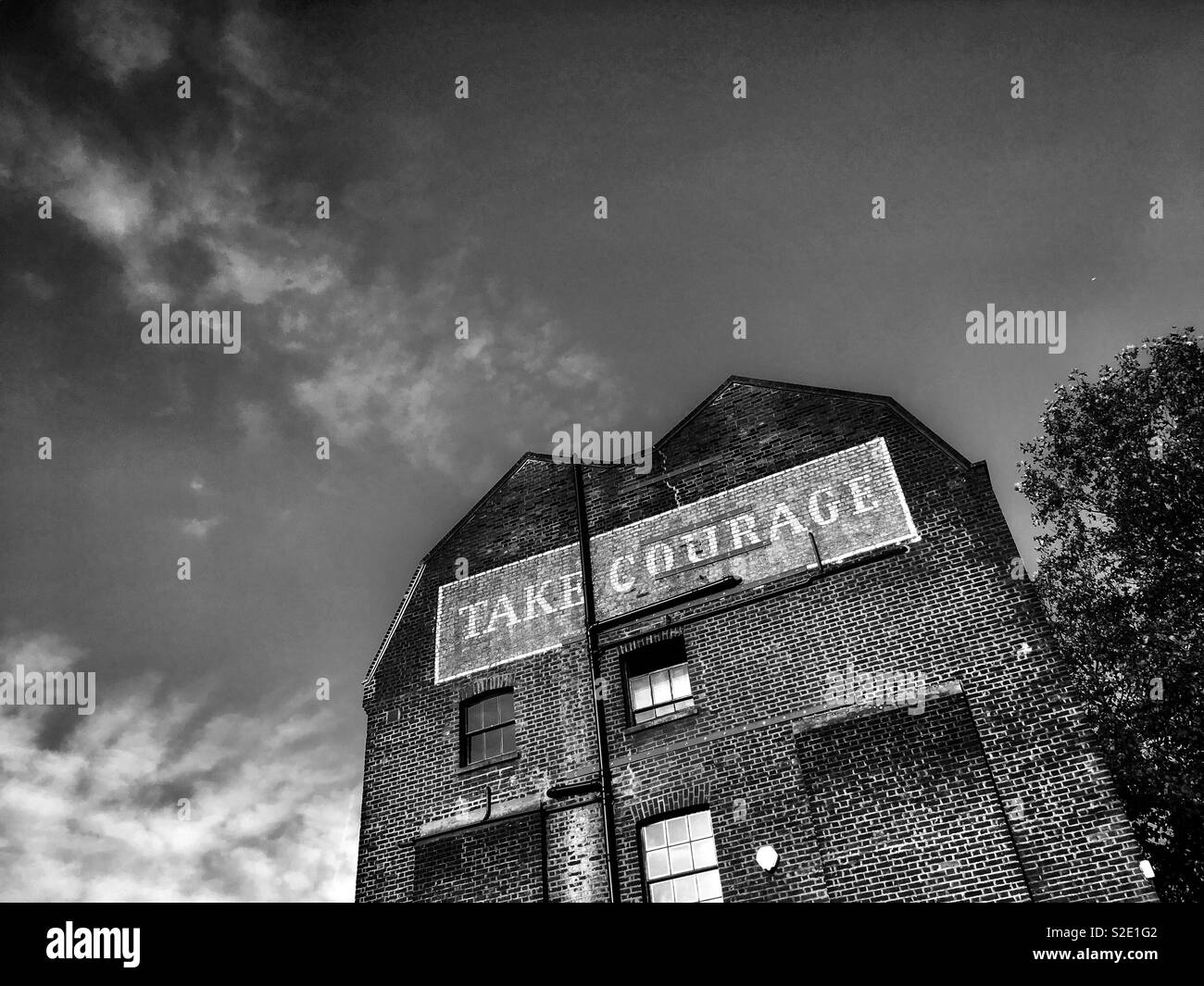 Take Courage Advert on What used to be The Courage & Co. Ltd Brewery in Southwark London in England - Smartphone Captured Stock Image