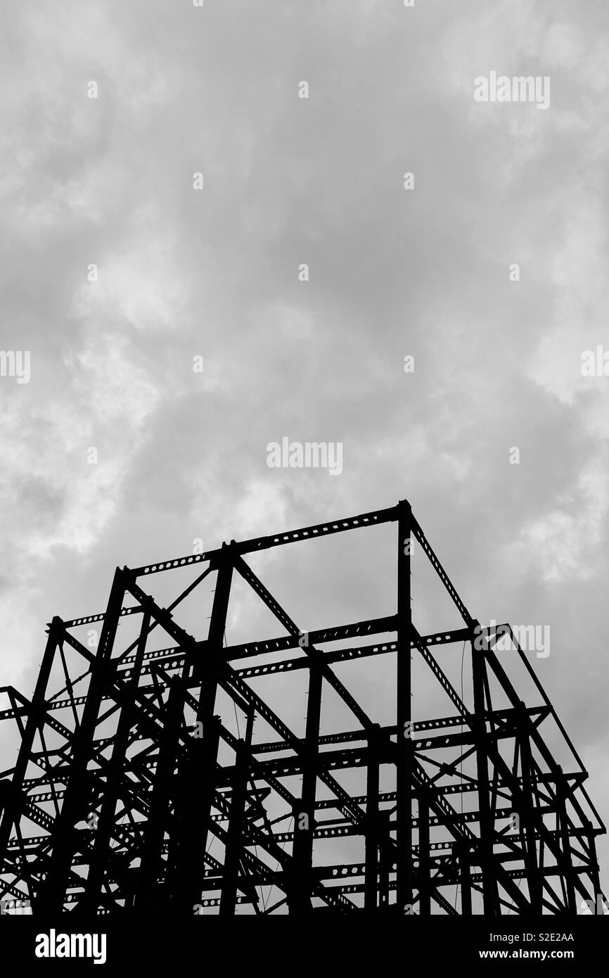 Abstract composition: geometrical metal construction with restless clouds Stock Photo