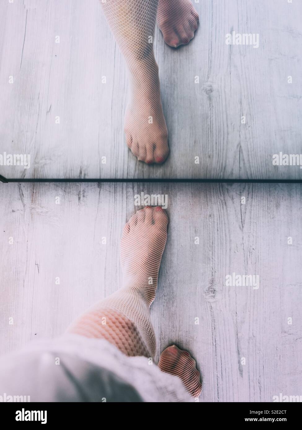 Woman’s legs next to a mirror - Smartphone Captured Stock Image