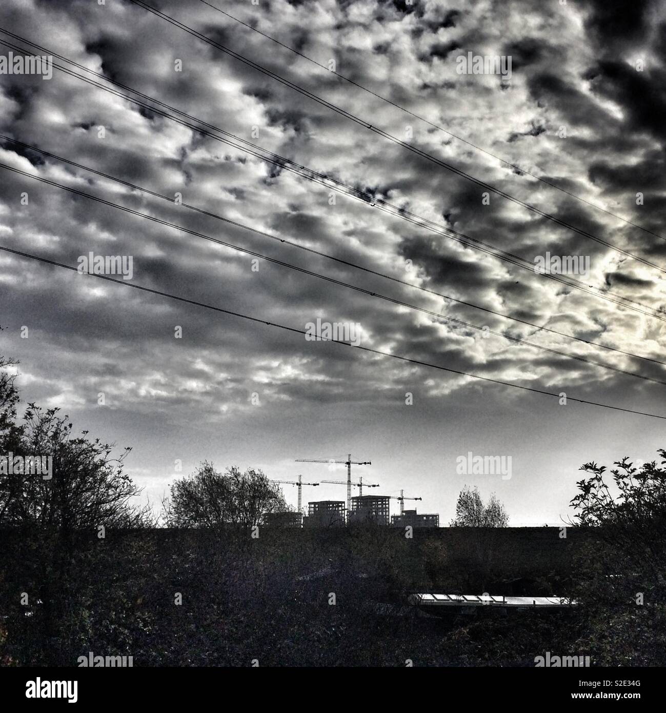 Cranes loom over a large building development in Walthamstow, London, UK - Smartphone Captured Stock Image