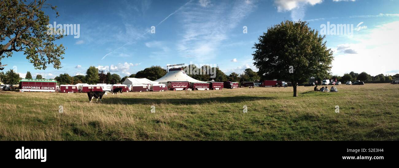 People arrive early for the evening showing of Giffords Circus on Minchinhampton Common. Mobile phone photo with some phone or tablet post processing. - Smartphone Captured Stock Image