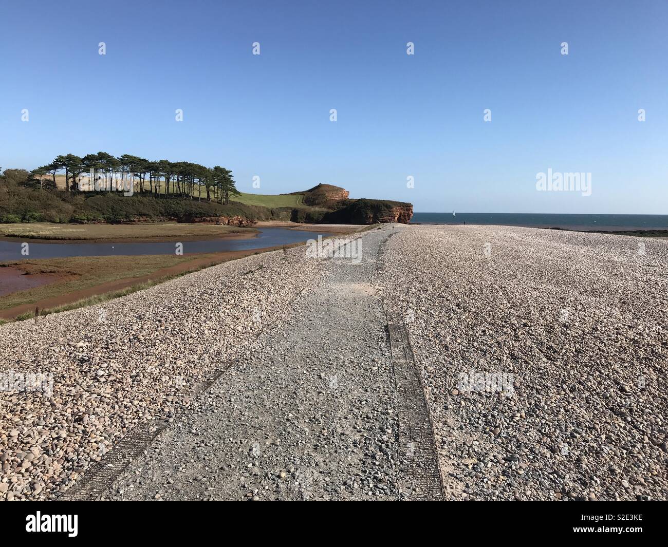 Pebbles, sea and sand Stock Photo - Alamy