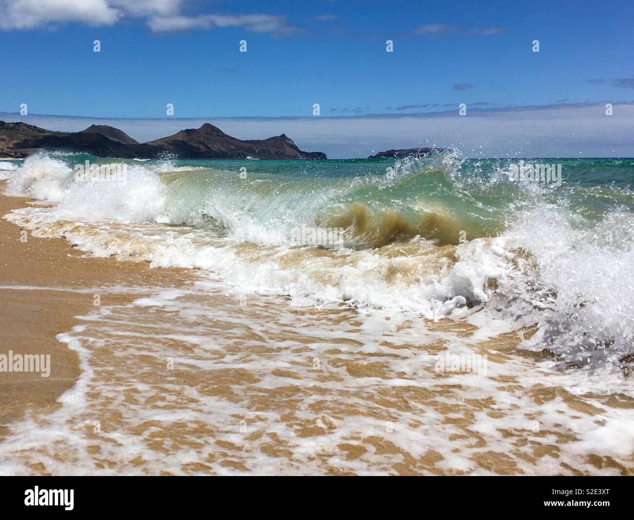Waves breaking on sand beach Porto Santo Island, Madeira, Portugal - Smartphone Captured Stock Image