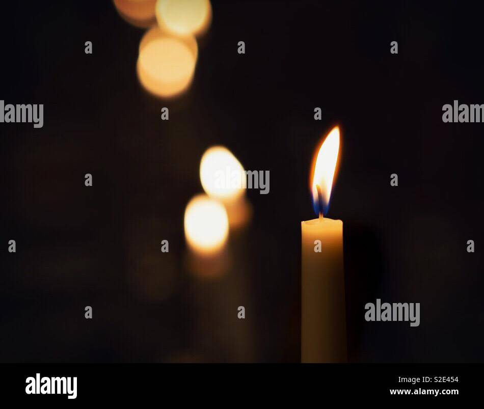 Candle burning remembrance and prayer - Smartphone Captured Stock Image