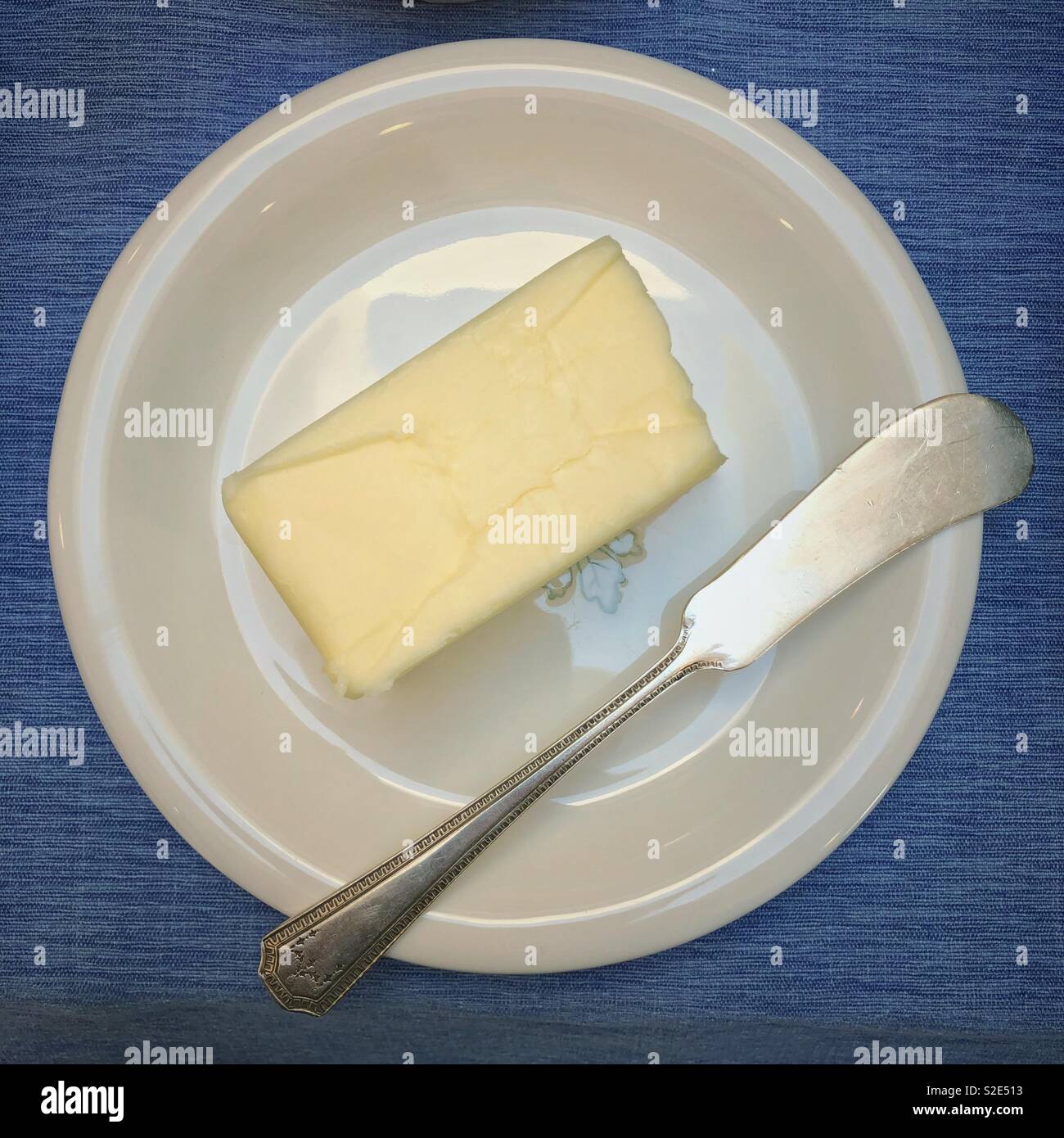 Butter on a plate with a knife Stock Photo Alamy