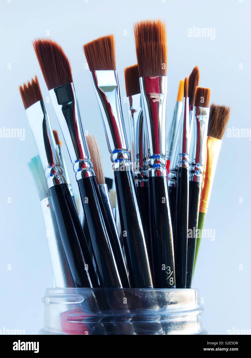 A variety of paintbrushes in a jar. Stock Photo
