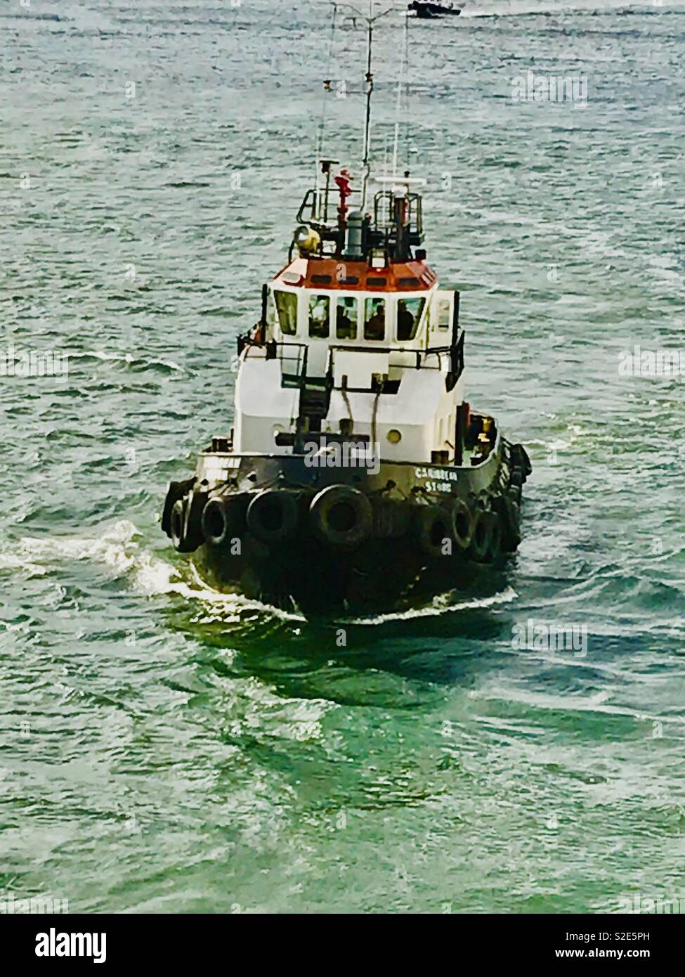Tug boat guiding ship hi-res stock photography and images - Alamy