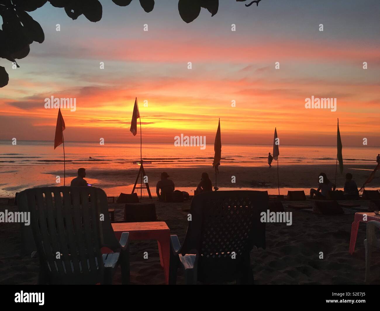 Sunset on the beach in Thailand beach bar and flags Stock Photo