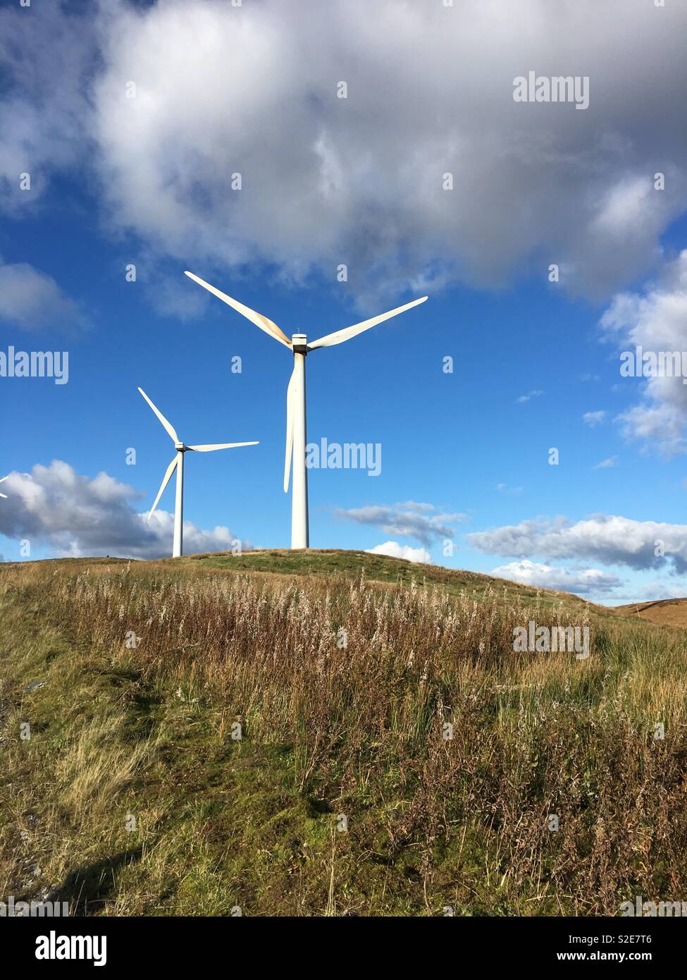 Wind farms in Myherin forest on a sunny day in Wales, UK Stock Photo