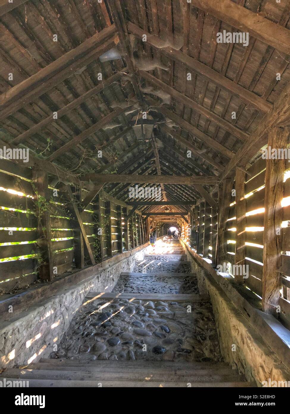 An old, preserved wooden covered walkway in Sighisoara, Romania. - Smartphone Captured Stock Image