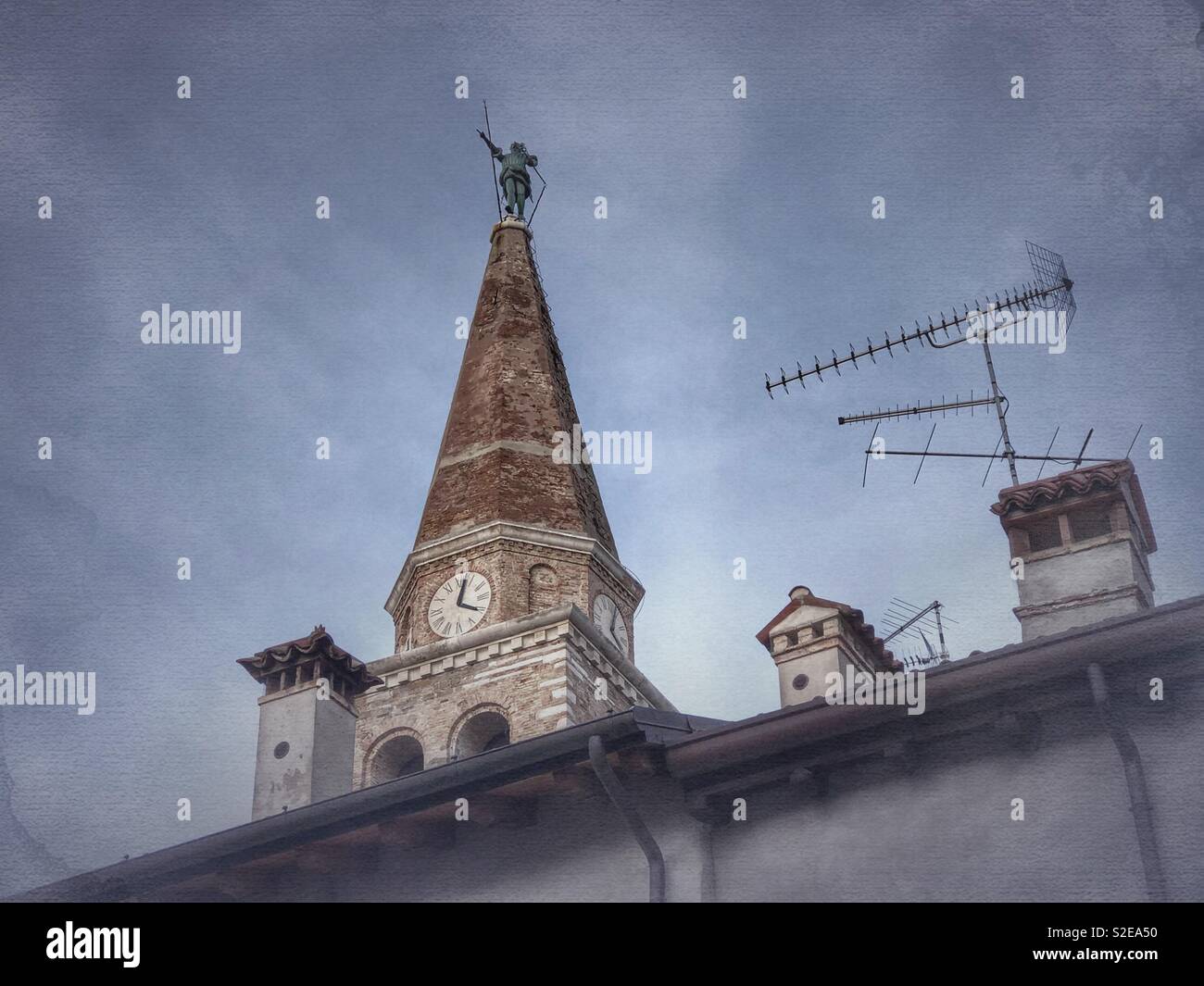Bell tower of the Basilica of Saint Euphemia with statue of Archangel Michael - Grado, Italy - Smartphone Captured Stock Image