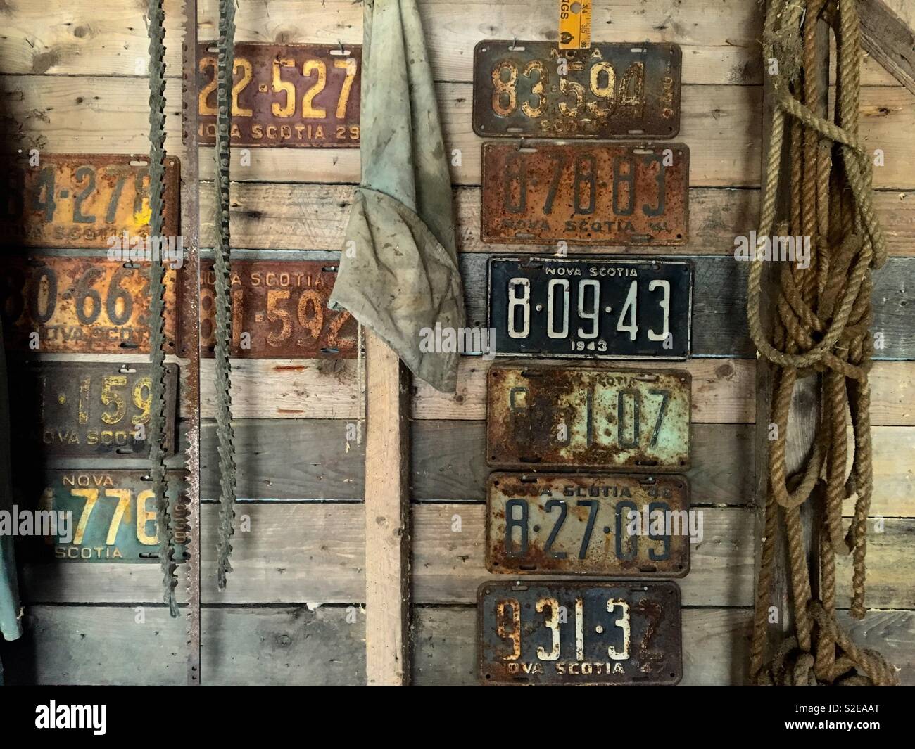 Old number plates of Nova Scotia Canada in an old wooden shed - Smartphone Captured Stock Image