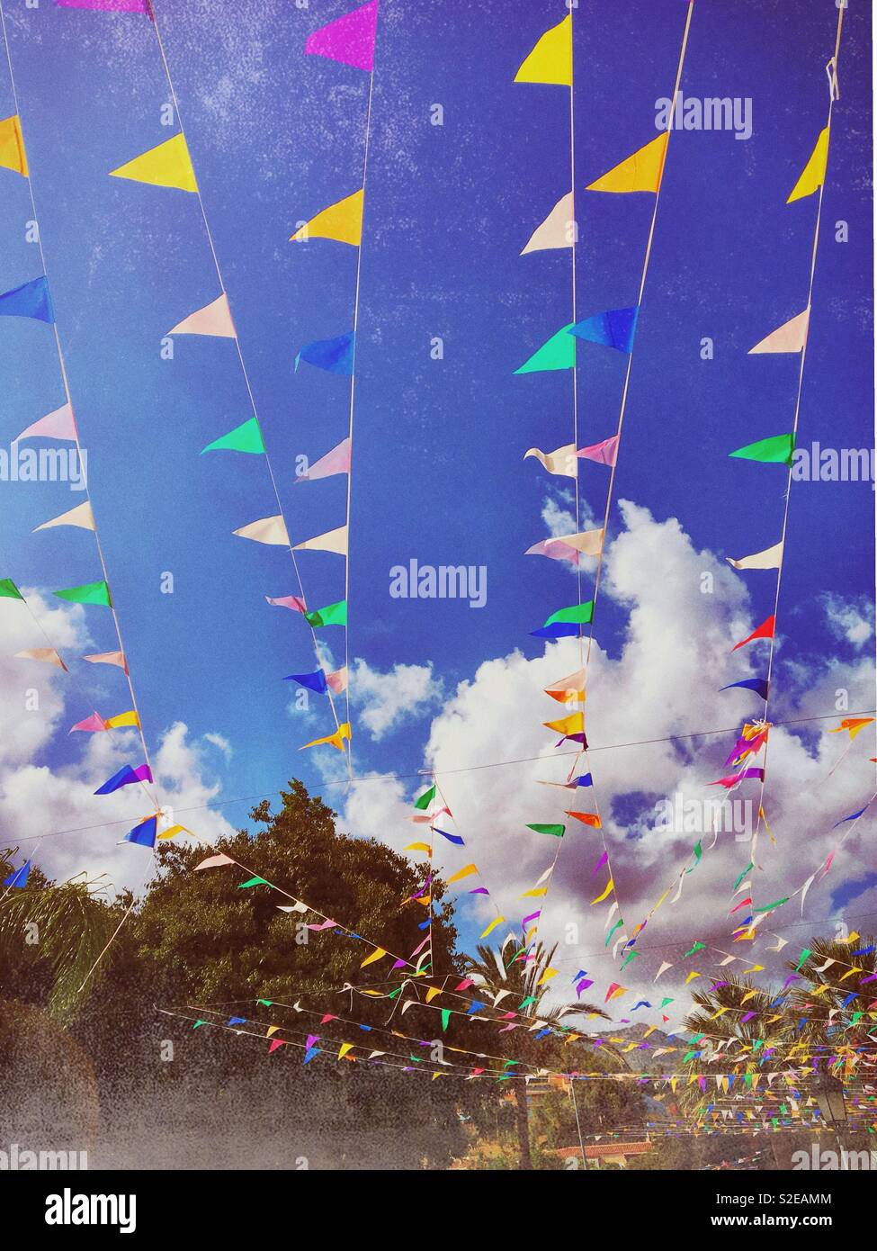 Colourful bunting flags against a Blue sky, province of Alicante, Costa Blanca Spain Stock Photo