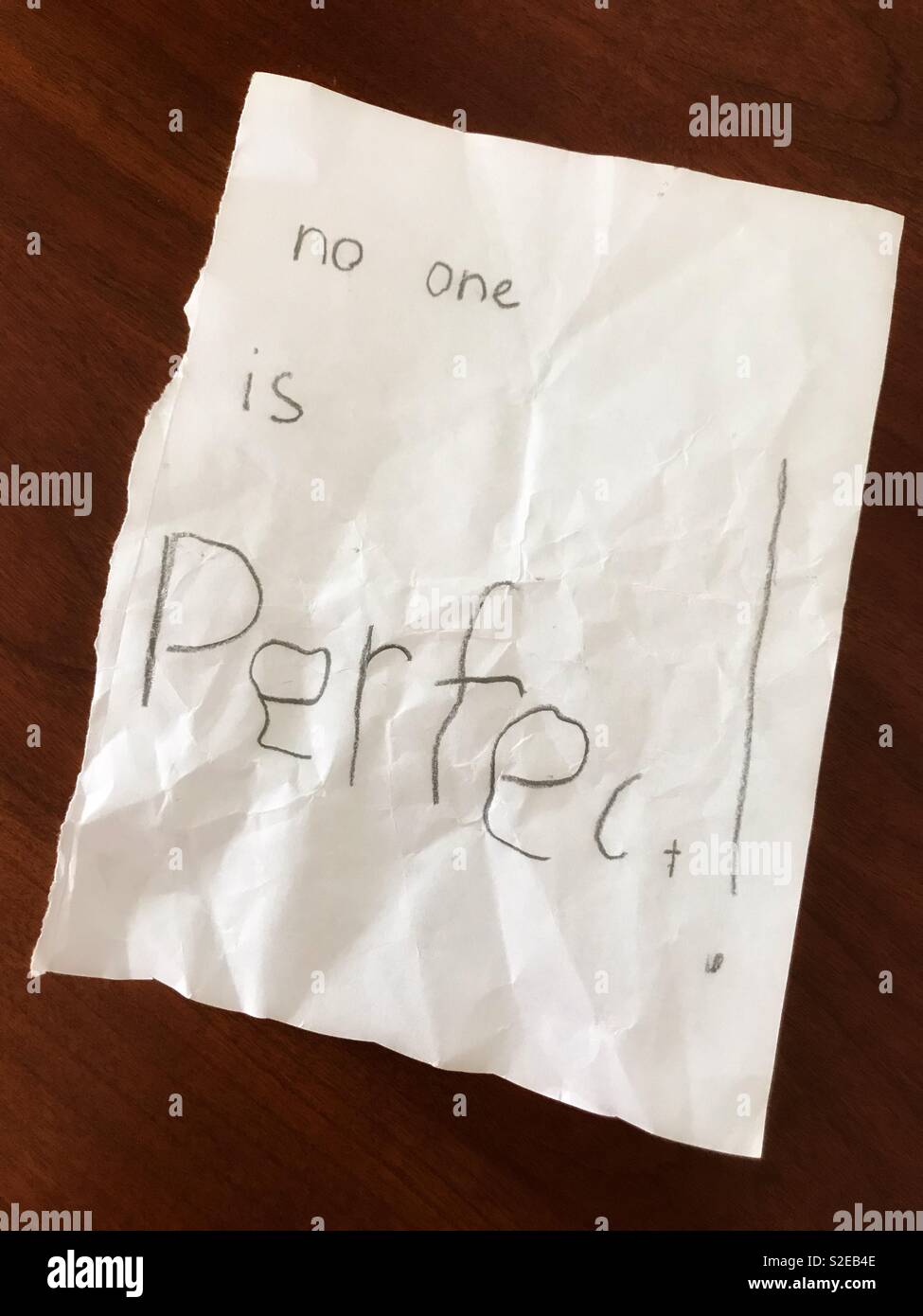 No one is perfect! imperfectly written on a scrap of paper. - Smartphone Captured Stock Image