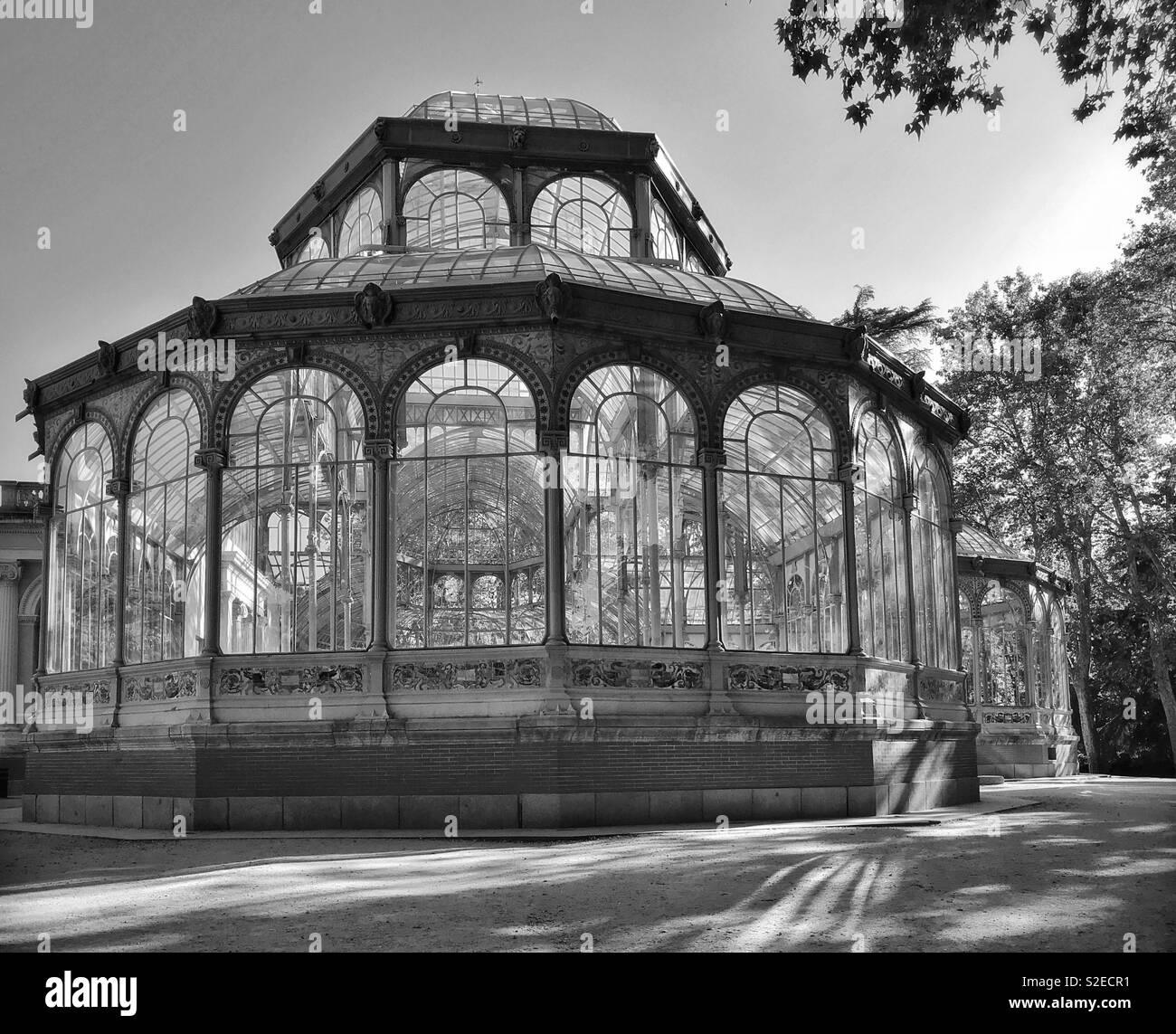 A monochrome picture of the Palacio de Cristal (Crystal Palace) in the Buen Retiro Park area of Madrid, Spain. This iron framework structure was completed in 1887, and is a must visit location. © CH. - Smartphone Captured Stock Image
