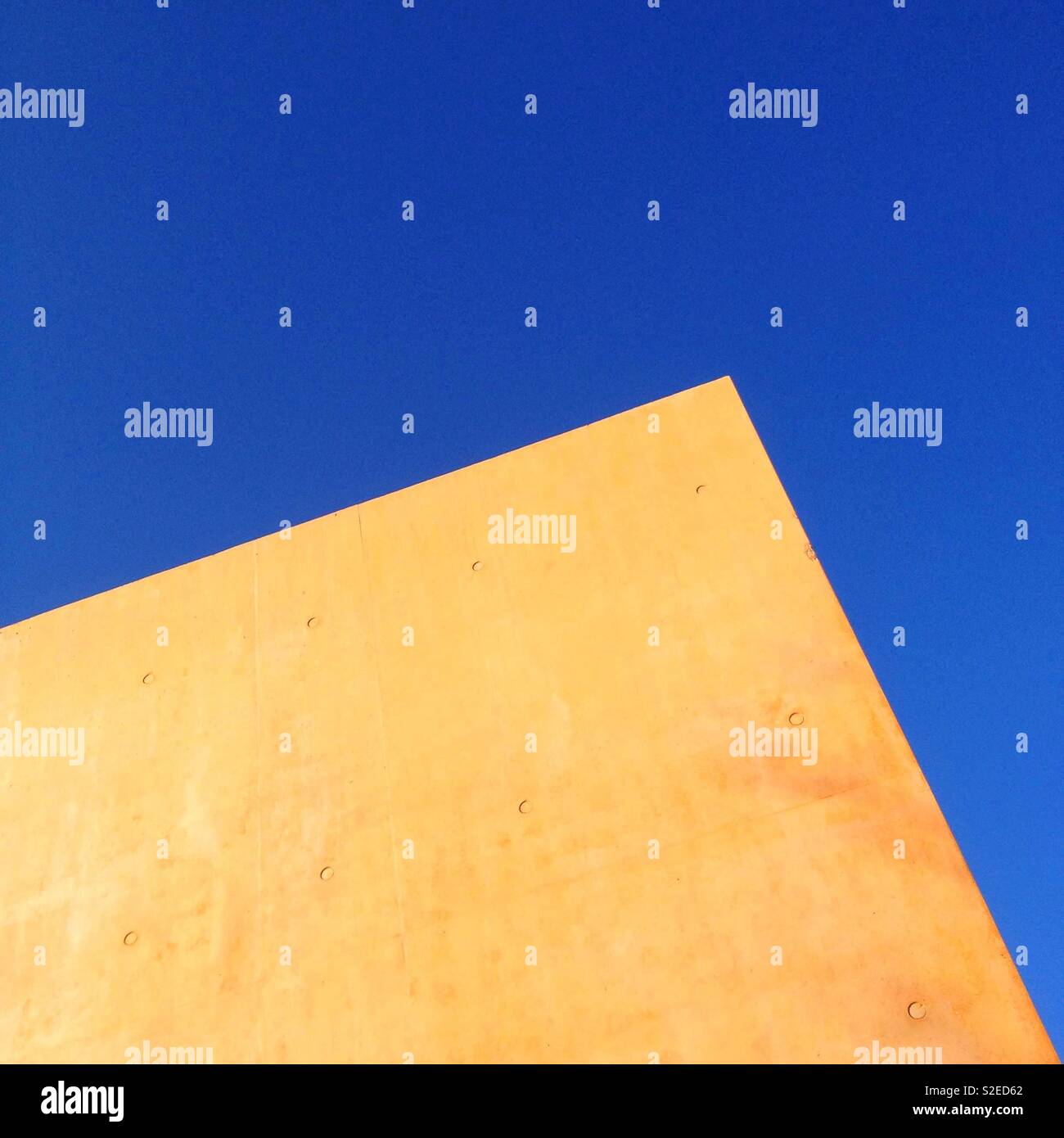 Tinted concrete wall and blue sky - Smartphone Captured Stock Image