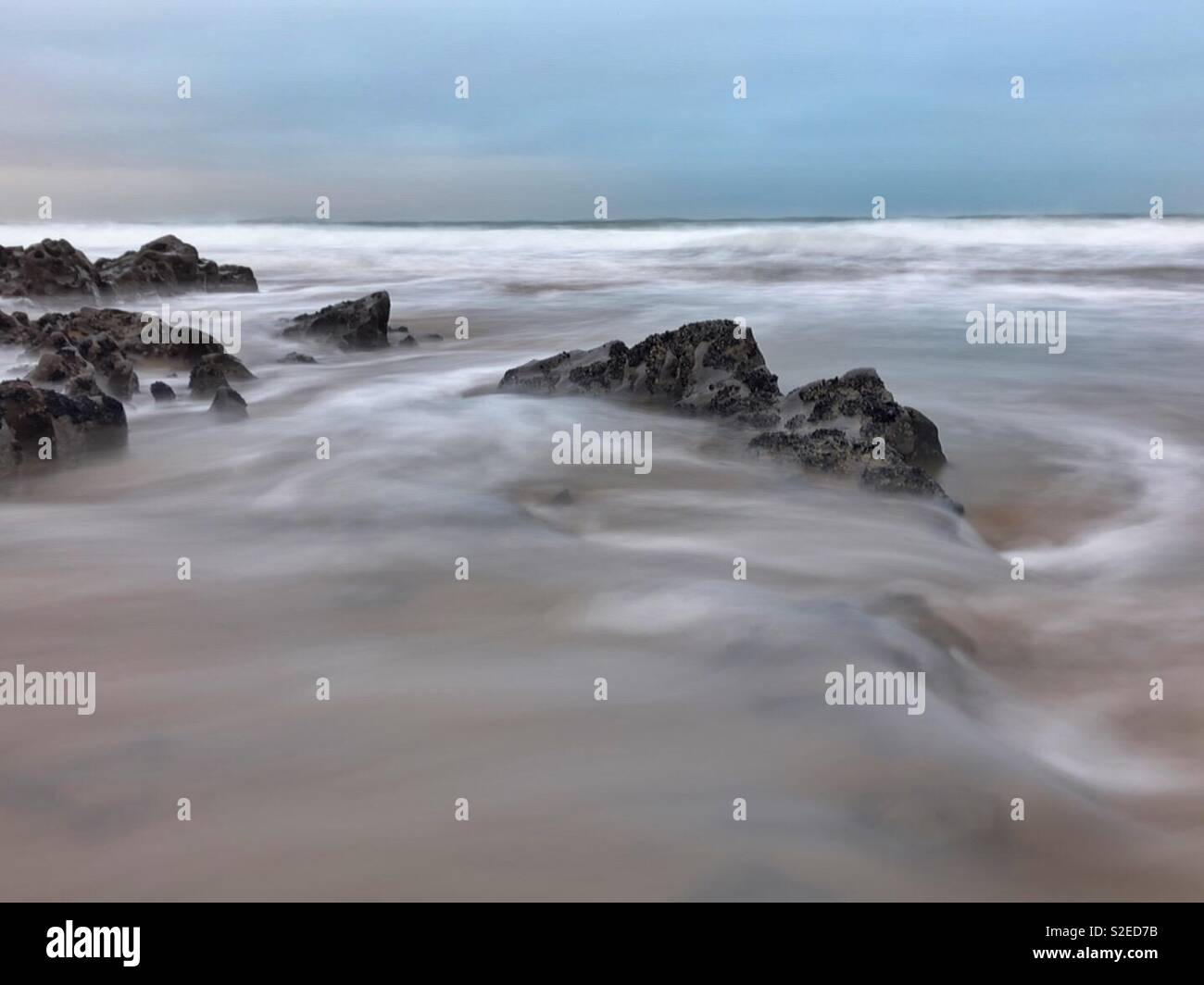 Tidal flow on a Welsh surf beach, November. - Smartphone Captured Stock Image