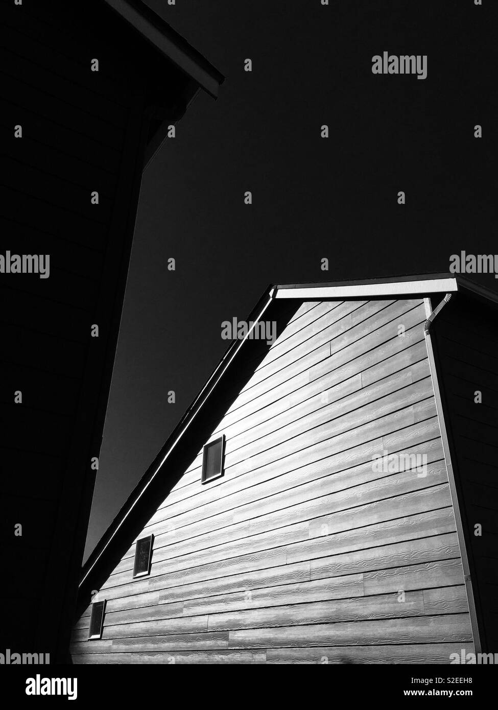 Dramatic monochromatic extior of an American suburban house - Smartphone Captured Stock Image