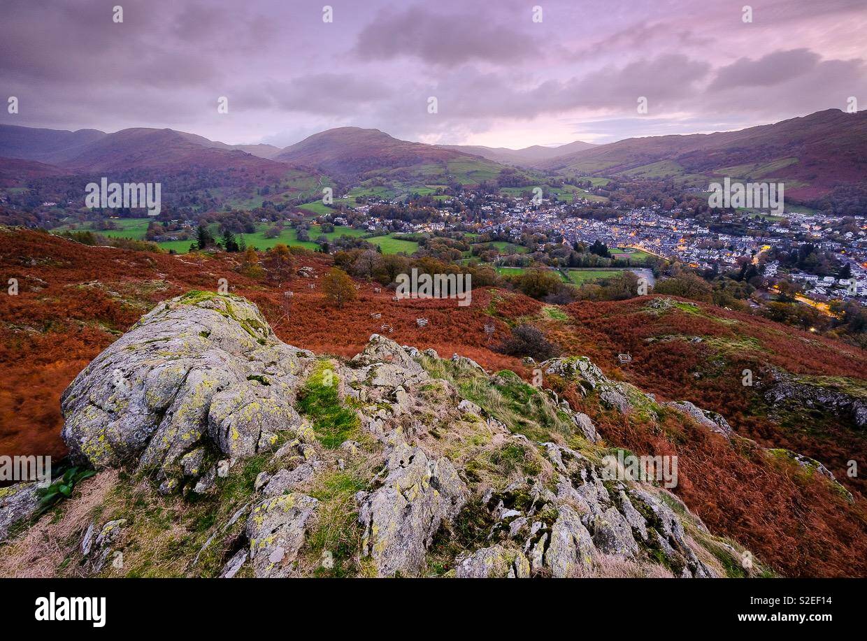 The view from Loughrigg fell at sunrise with cottages with lights on. - Smartphone Captured Stock Image