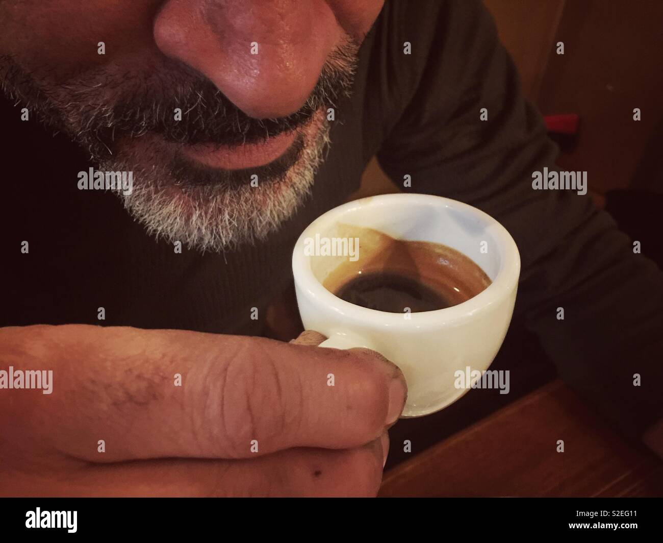 Close up of a man drinking espresso coffee - Smartphone Captured Stock Image