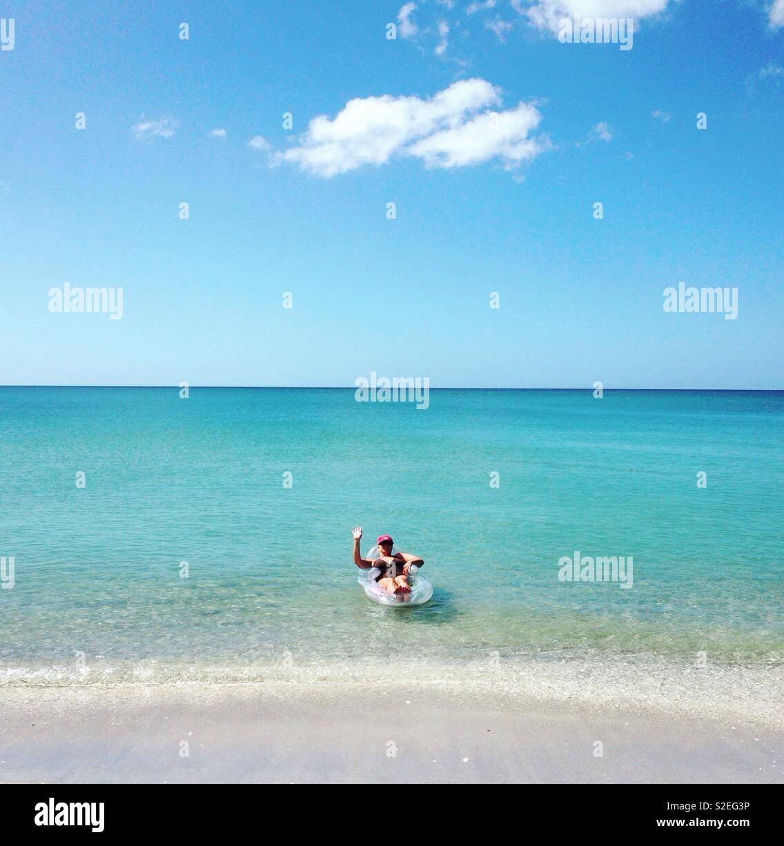 Woman on vacation, woman on beach, woman in ocean - Smartphone Captured Stock Image