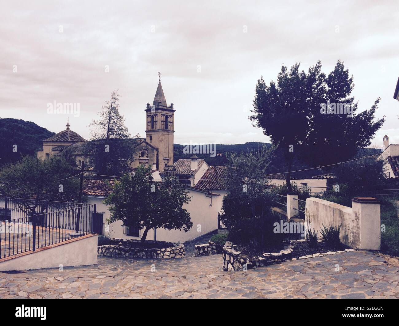 Landscape view of a village in Andalucia Spain with a church steeple in the background and houses in front Stock Photo