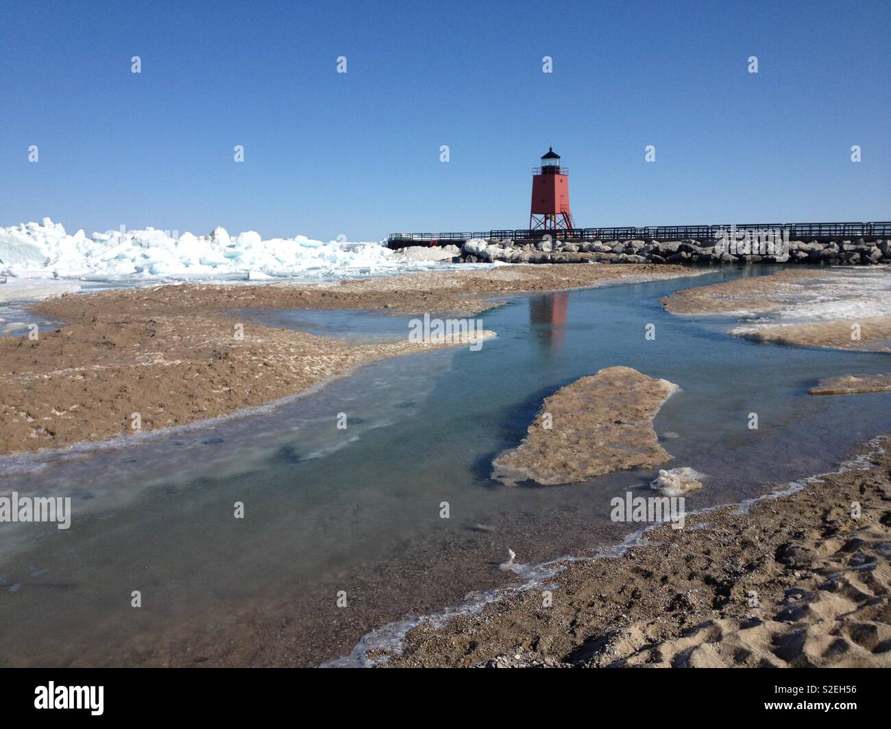 Ice piles in beach along lighthouse in Charlevoix - Smartphone Captured Stock Image