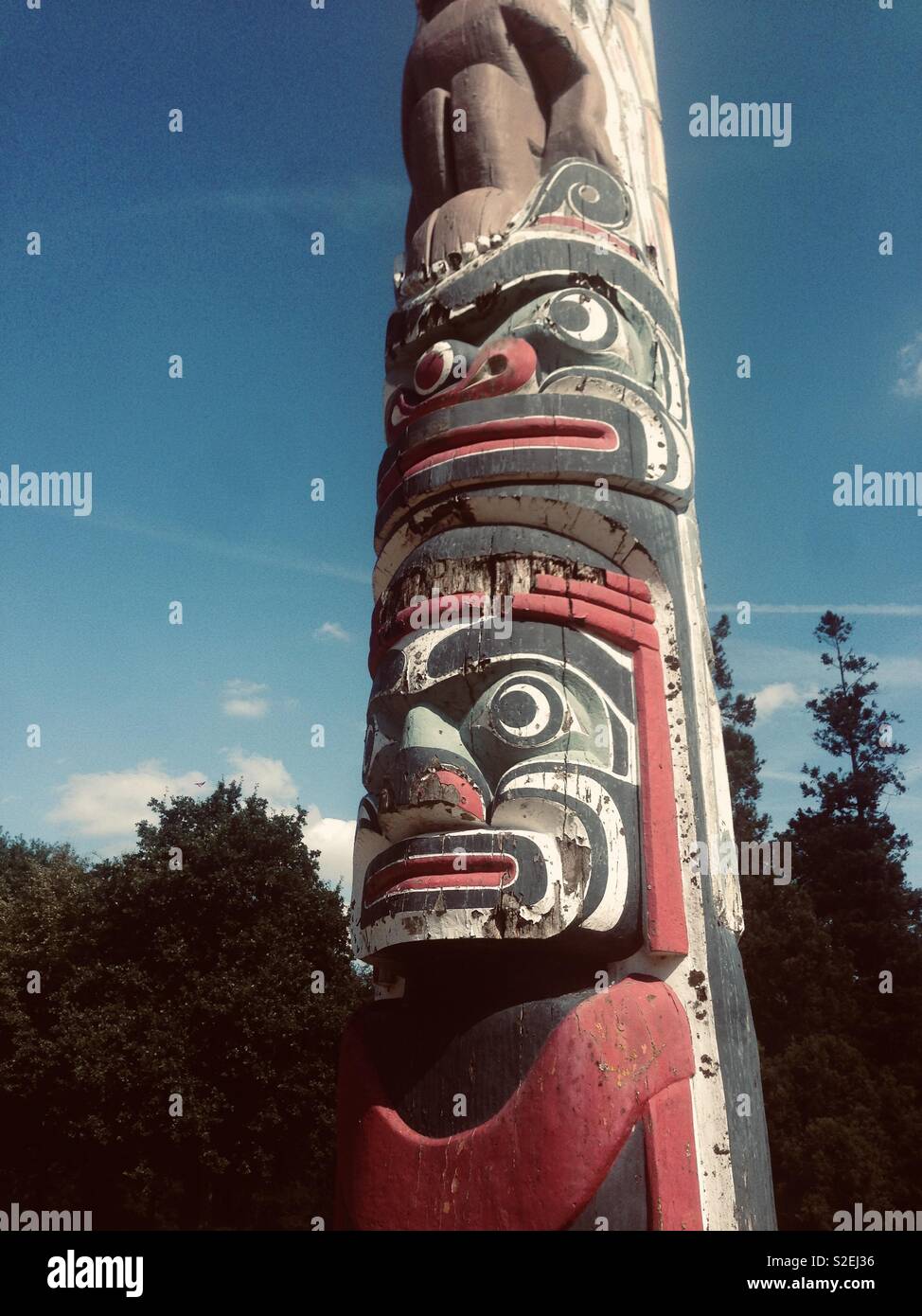 Colourful totem pole in the sun Stock Photo