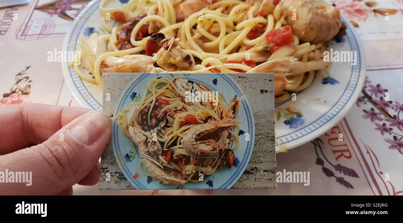 Noodles with seafood and instant picture of the italian dish - Smartphone Captured Stock Image