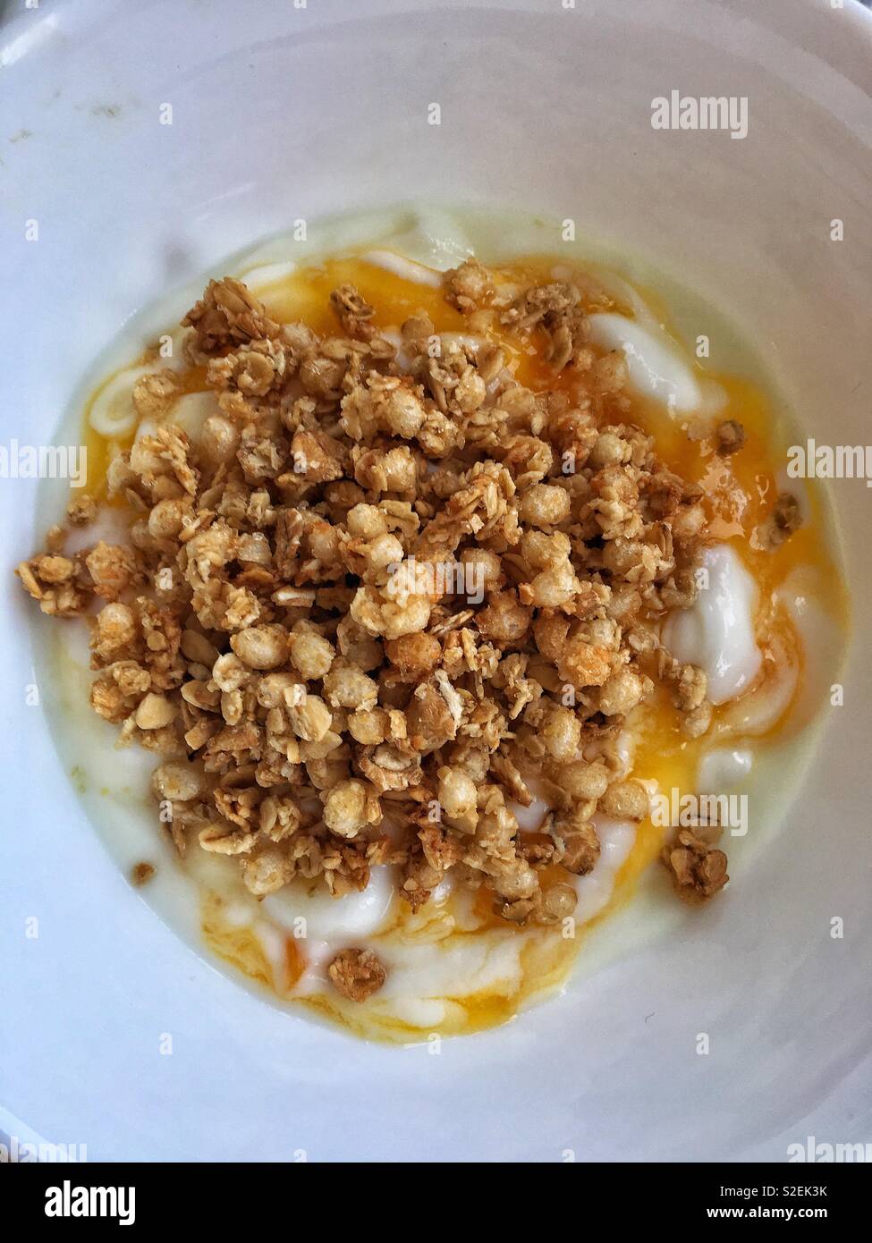 Passion fruit yogurt with granola Stock Photo