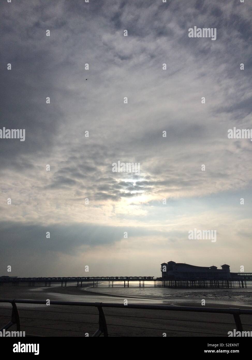 Silhouette of Weston-Super-Mare Pier under threatening clouds Stock Photo