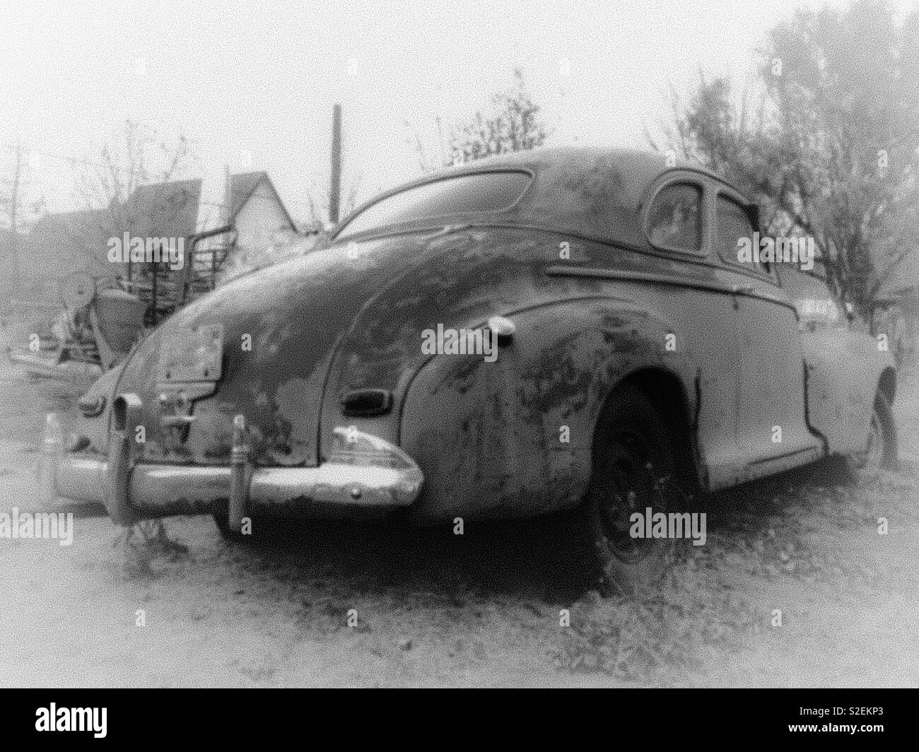 Misty black and white photo of vintage Chevrolet coupe taken from the right rear - Smartphone Captured Stock Image