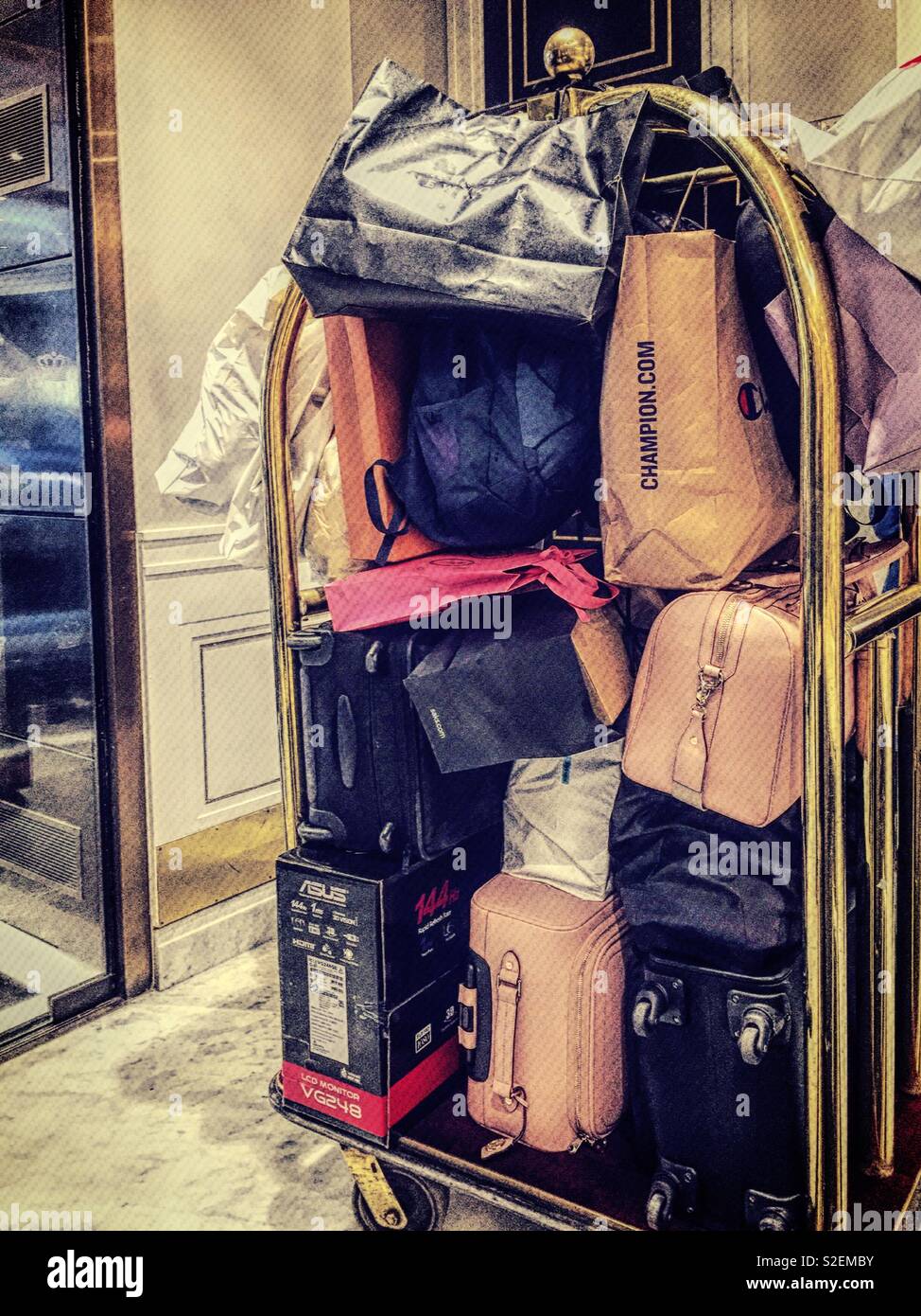 Luggage cart jammed with baggage in the lobby of an upscale New York City hotel, United States - Smartphone Captured Stock Image