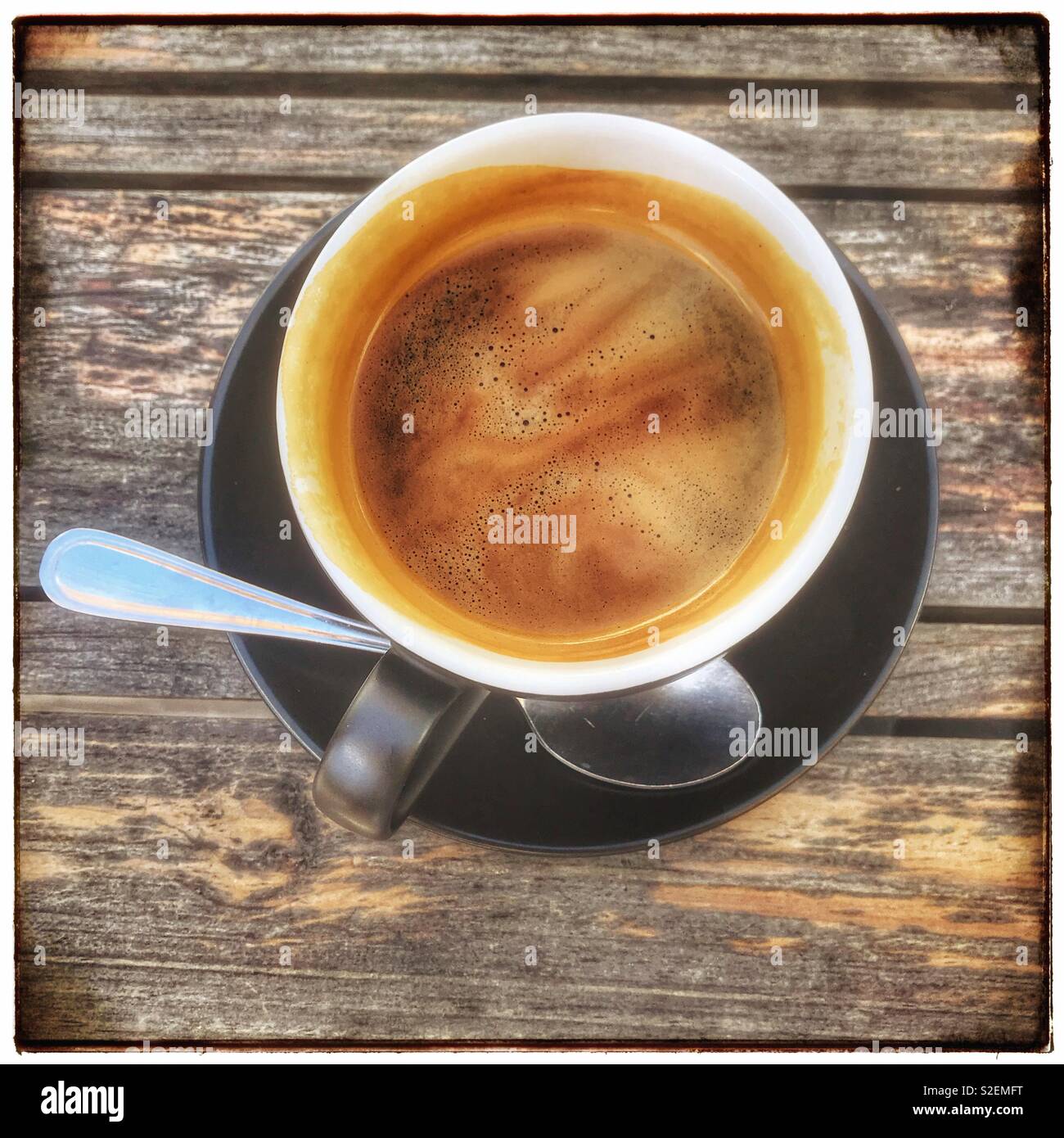 Cup of black coffee on wooden table. - Smartphone Captured Stock Image
