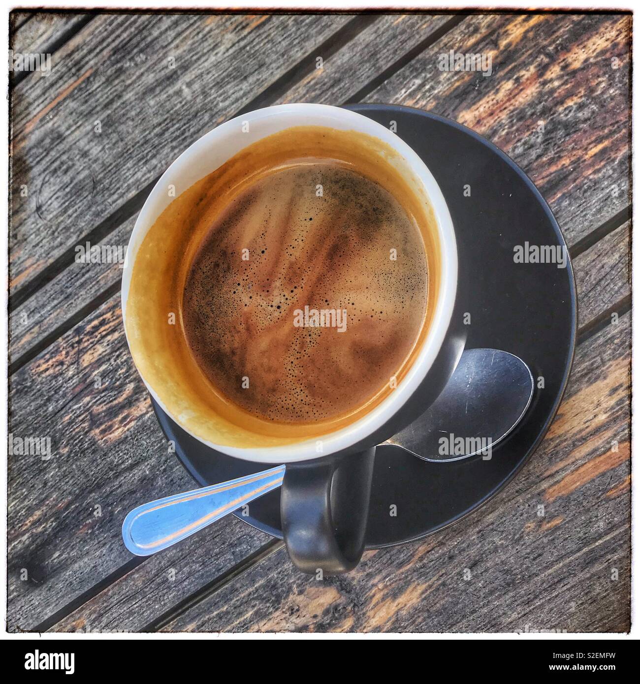 Cup of black coffee on wooden table. - Smartphone Captured Stock Image
