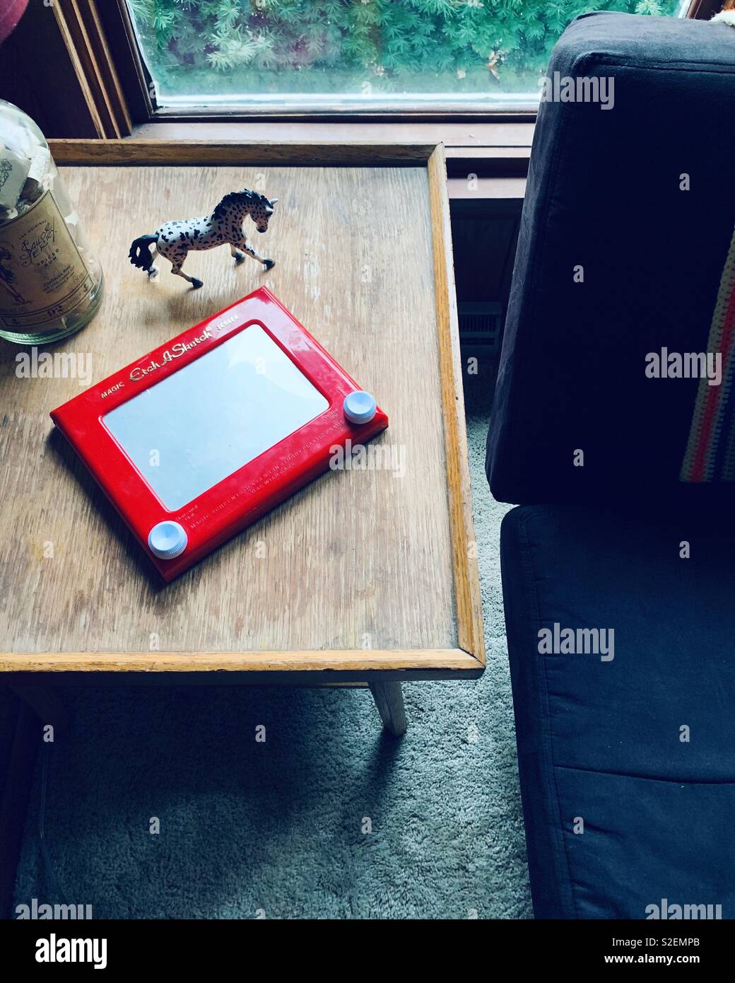 EtchASketch toy on a table inside a home by the window Stock Photo