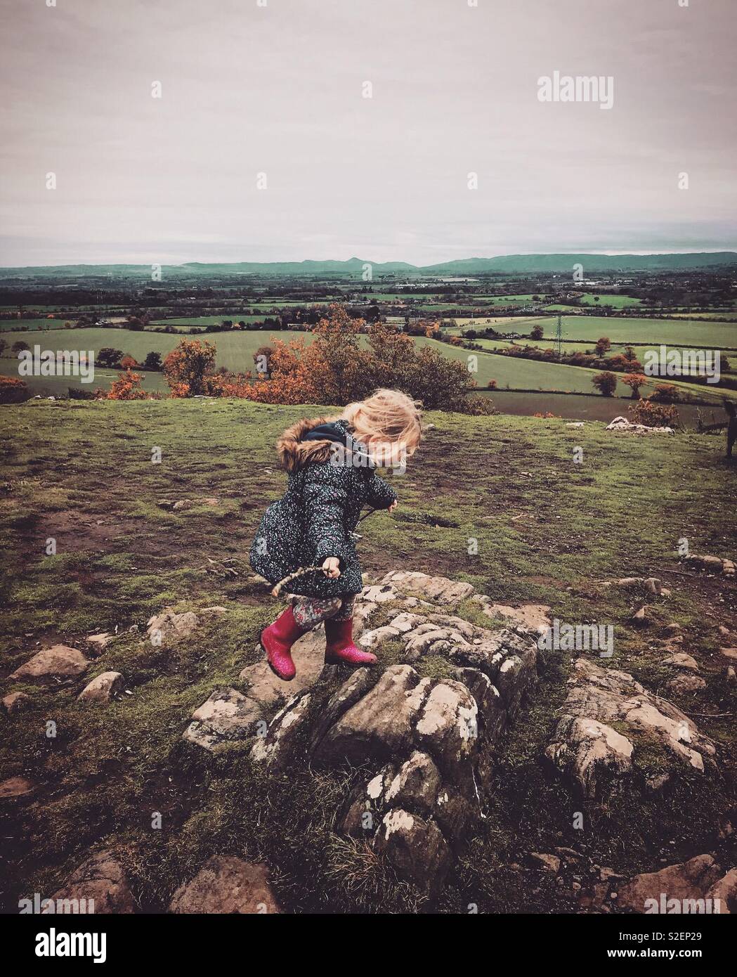 Across The Rocks Child walks across the rocks with scenic background Stock Photo - Alamy